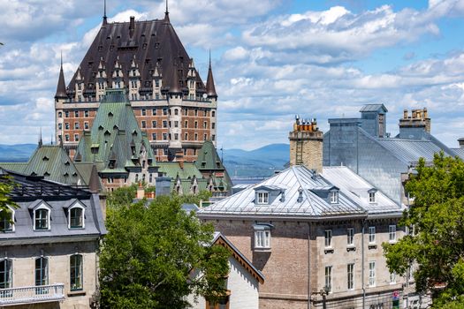 Capture of the iconic Château Frontenac amidst Quebec City's classic architecture under a vibrant summer sky.