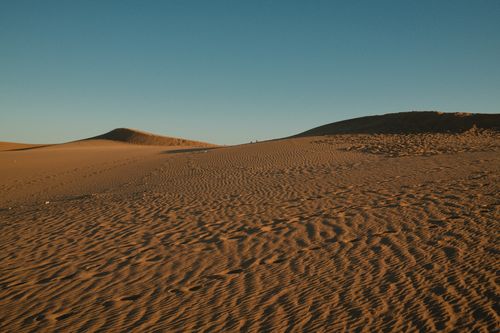 Free Stunning landscape of sand dunes under a clear blue sky in Spain's desert terrain. Stock Photo