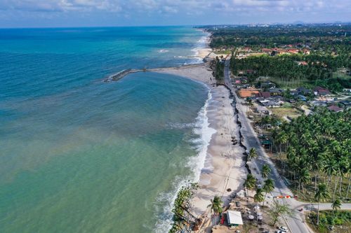 Free A stunning aerial view of Kuala Terengganu's coastline featuring lush greenery and clear blue waters. Stock Photo