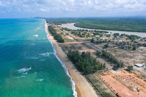 Free Aerial view of the beach and coastline in Permaisuri, Terengganu, Malaysia, showcasing turquoise waters and lush greenery. Stock Photo