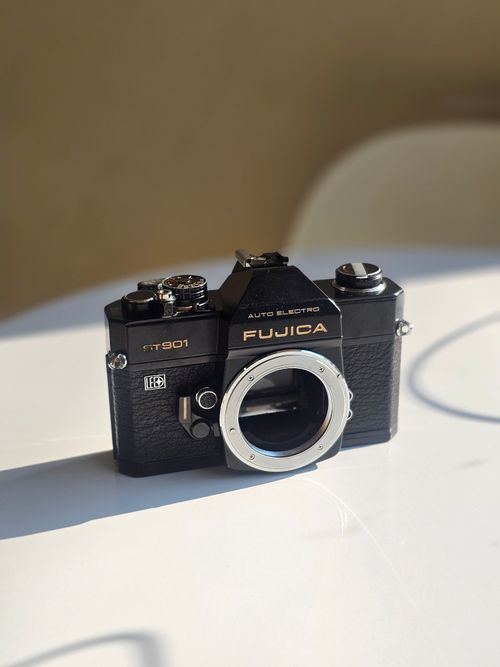 Free Classic black Fujica GT901 camera on a white surface, showcasing vintage design. Stock Photo