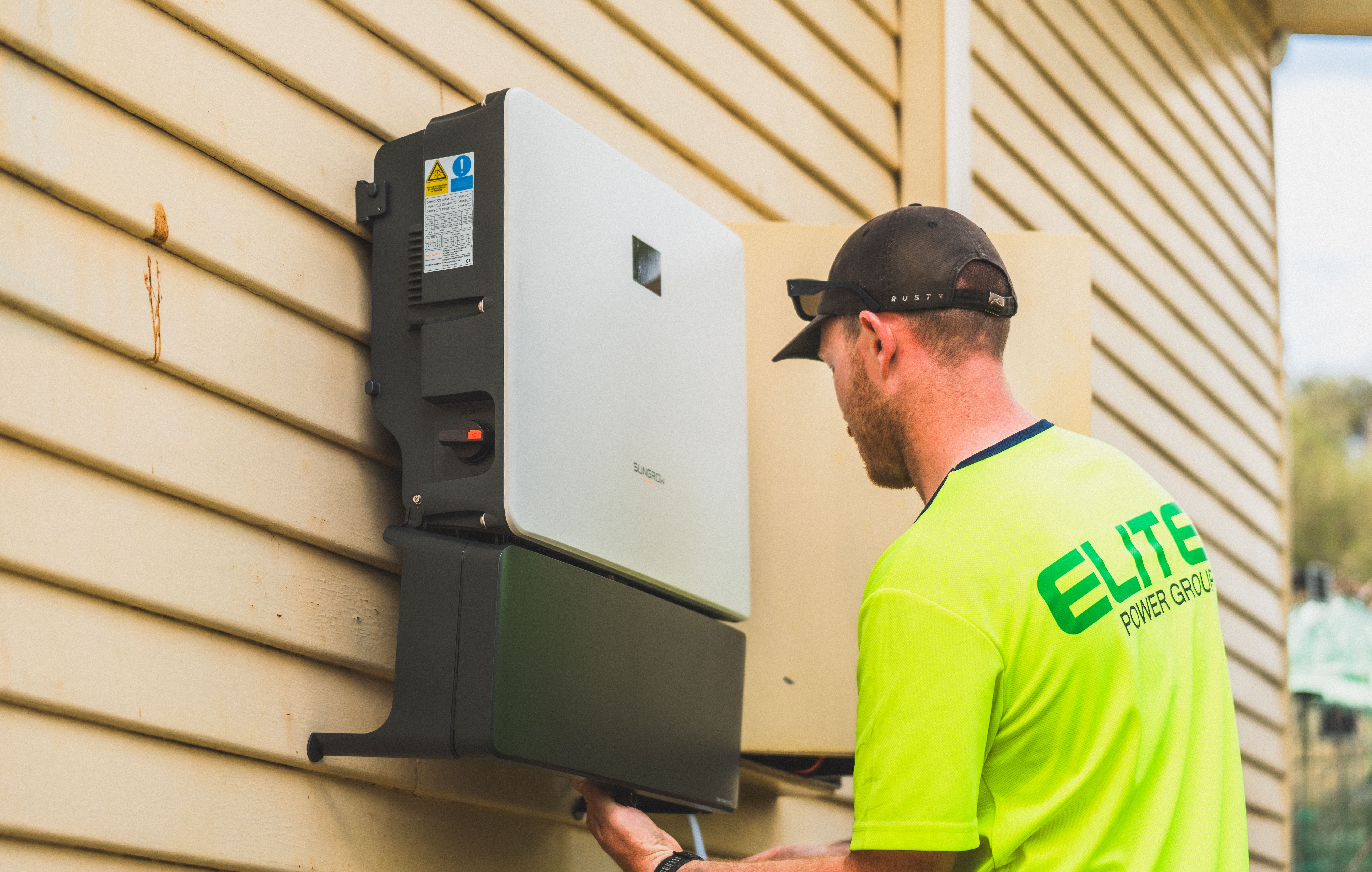 Technician installing a modern solar inverter