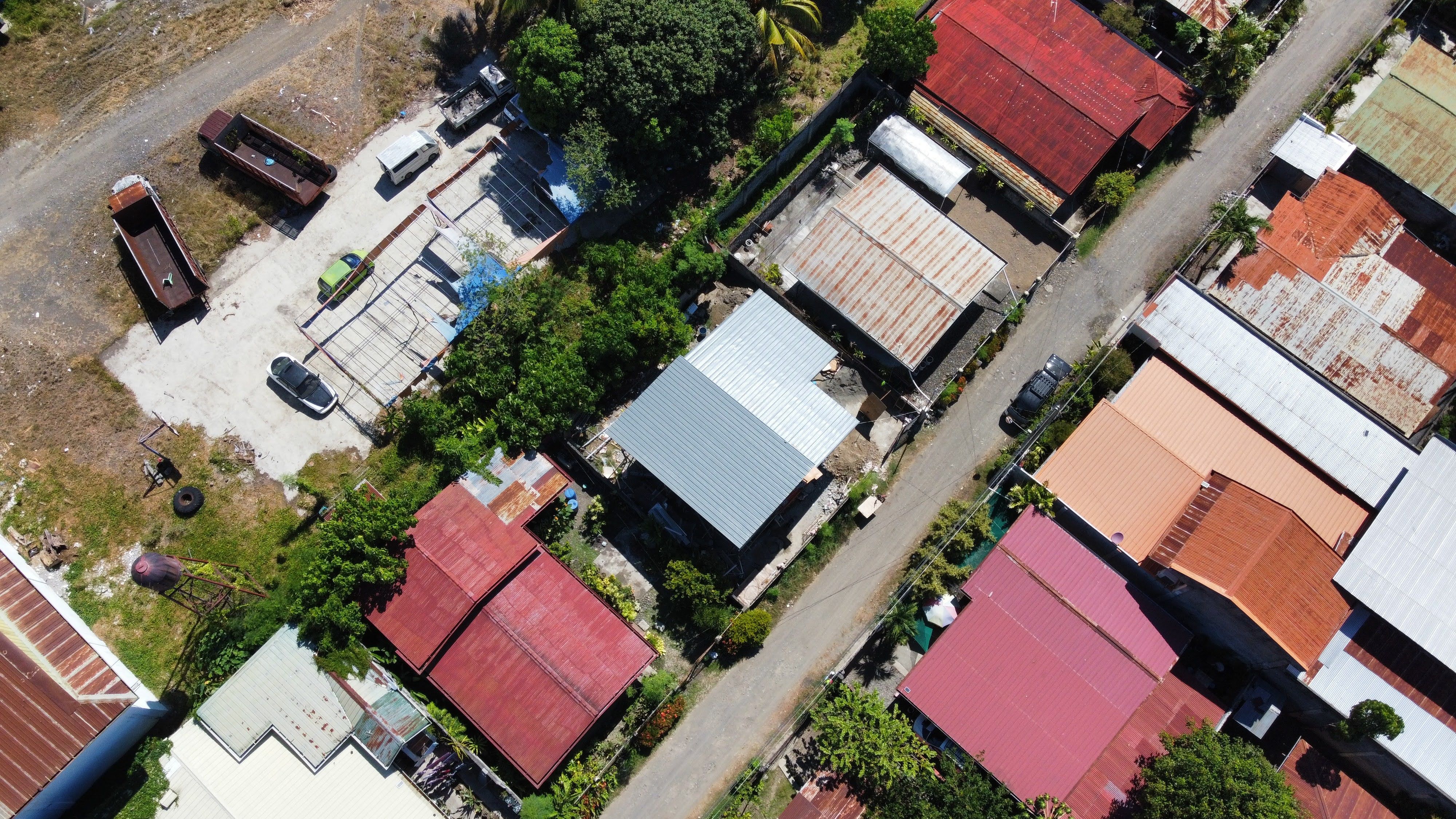 Aerial shot of colorful rooftops in a residential area with lush greenery in Davao City, Philippines.