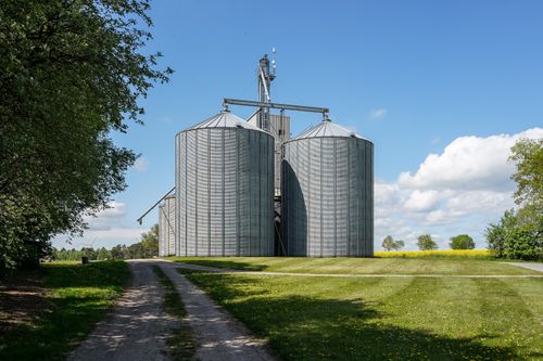 Free Rural grain silos with blue skies in Gülzow, Schleswig-Holstein, Germany. Stock Photo