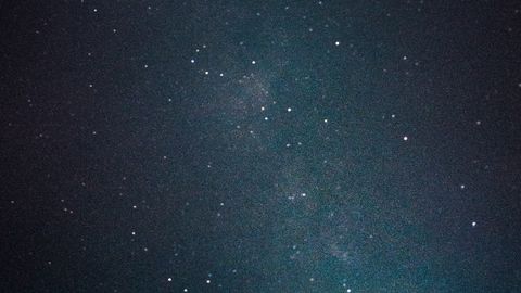 A captivating view of a starry night sky featuring the Milky Way galaxy's bright core.