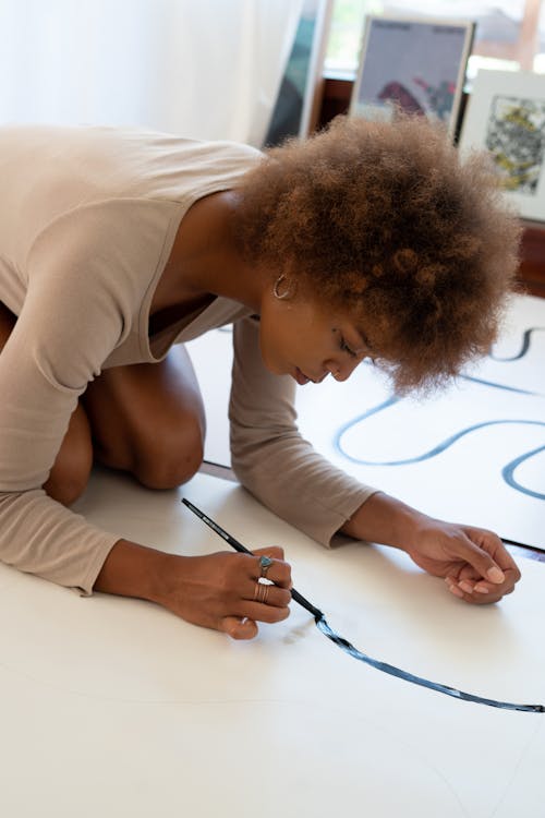 Woman in White Shirt Painting on White Paper