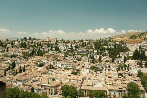 Free Aerial view of Granada, Spain, showcasing historic architecture and scenic landscape under a clear sky. Stock Photo