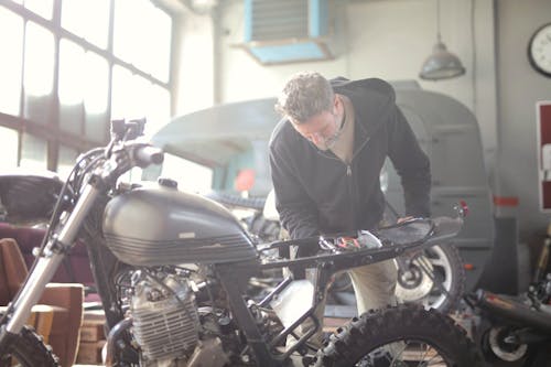 Man in Gray Suit Jacket Standing Near Motorcycle