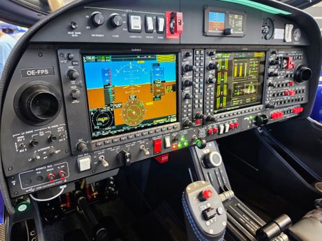 Detailed view of airplane cockpit controls and instrument panels highlighting avionics.