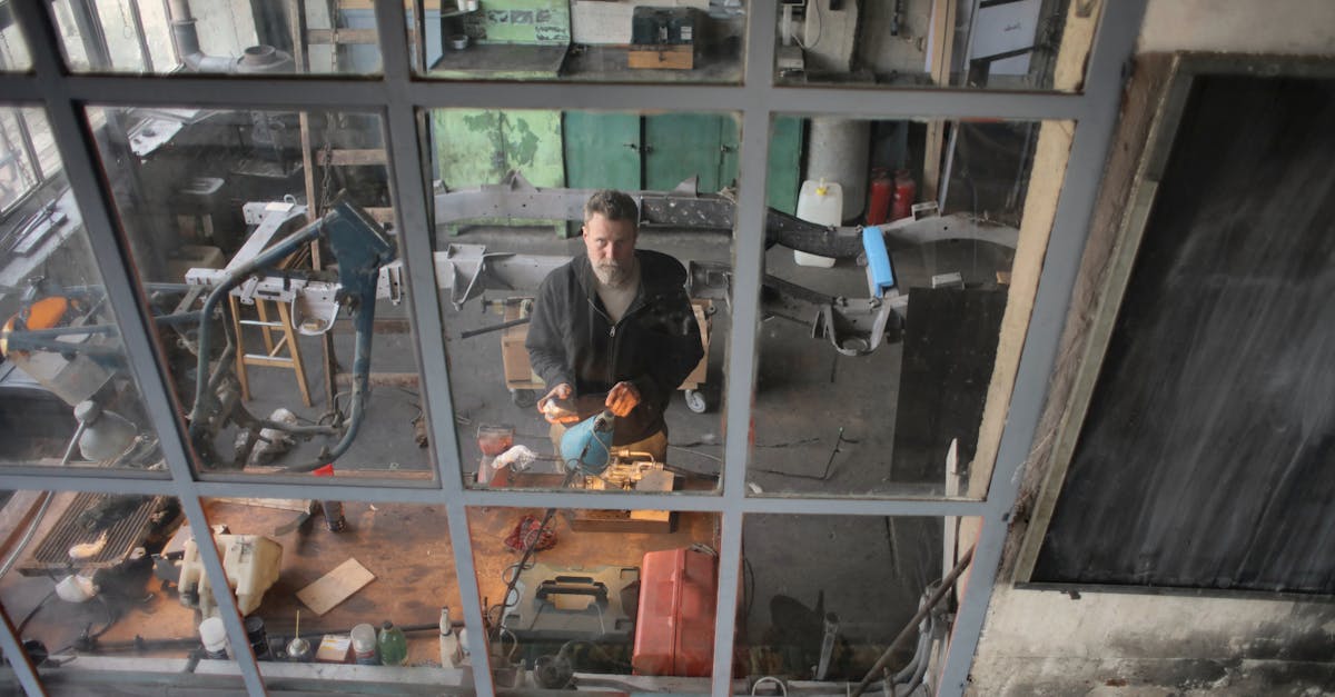 Serious bearded male mechanic working in workshop