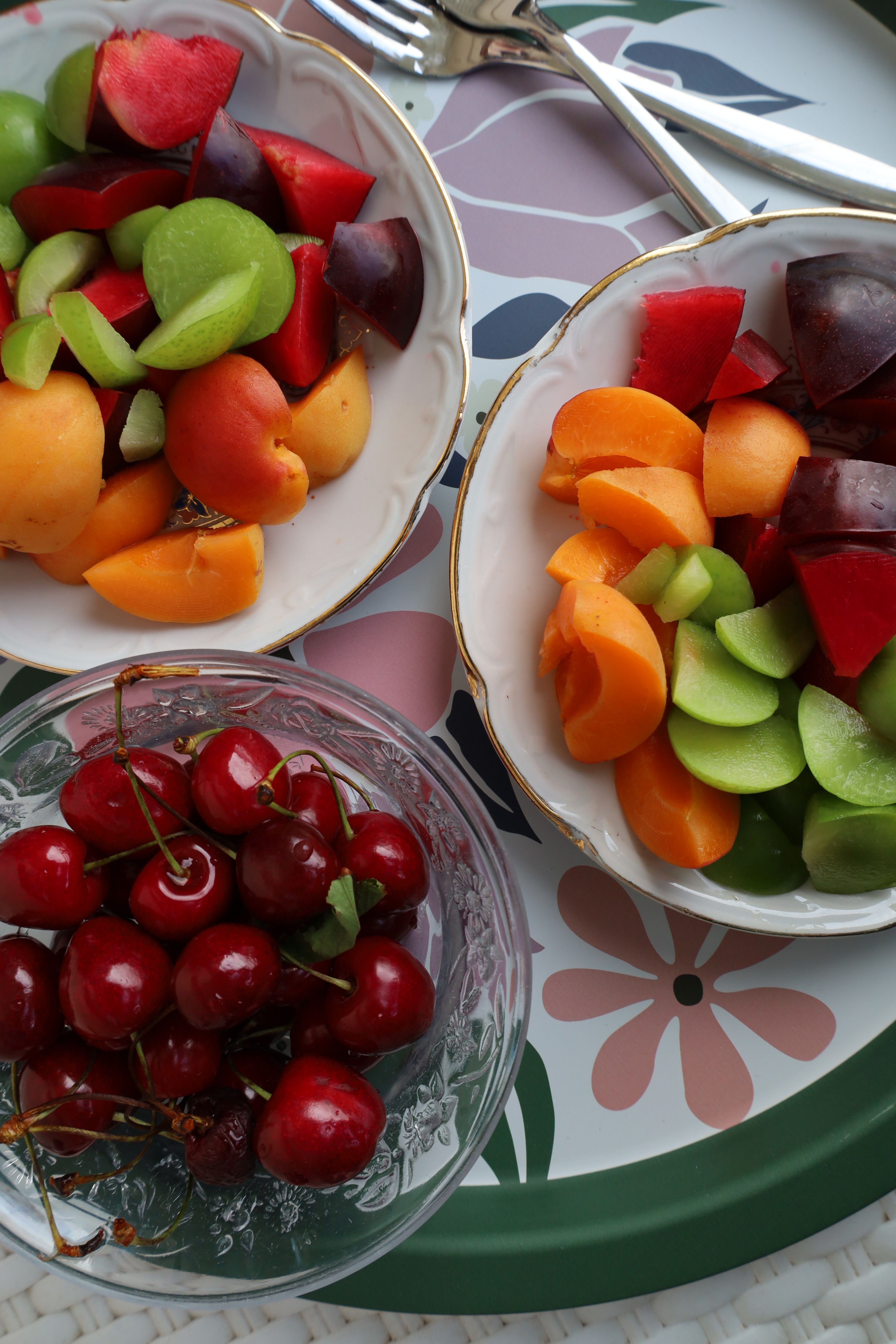 Colorful assortment of fresh summer fruits in elegant bowls, perfect for a refreshing snack.