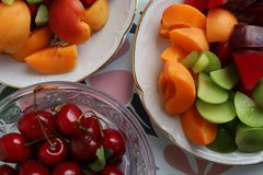 Colorful assortment of fresh summer fruits in elegant bowls, perfect for a refreshing snack.