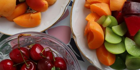 Colorful assortment of fresh summer fruits in elegant bowls, perfect for a refreshing snack.