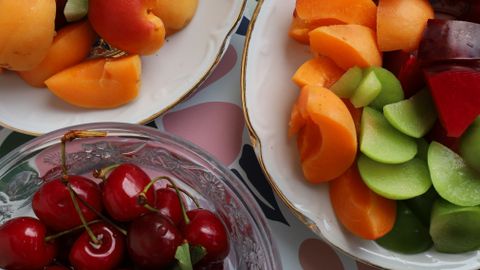 Colorful assortment of fresh summer fruits in elegant bowls, perfect for a refreshing snack.