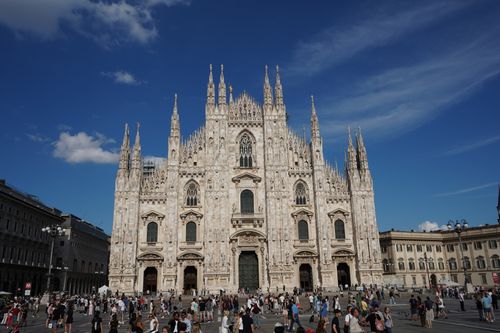 Free Beautiful perspective of Milan Cathedral with a bustling crowd in the piazza. Stock Photo