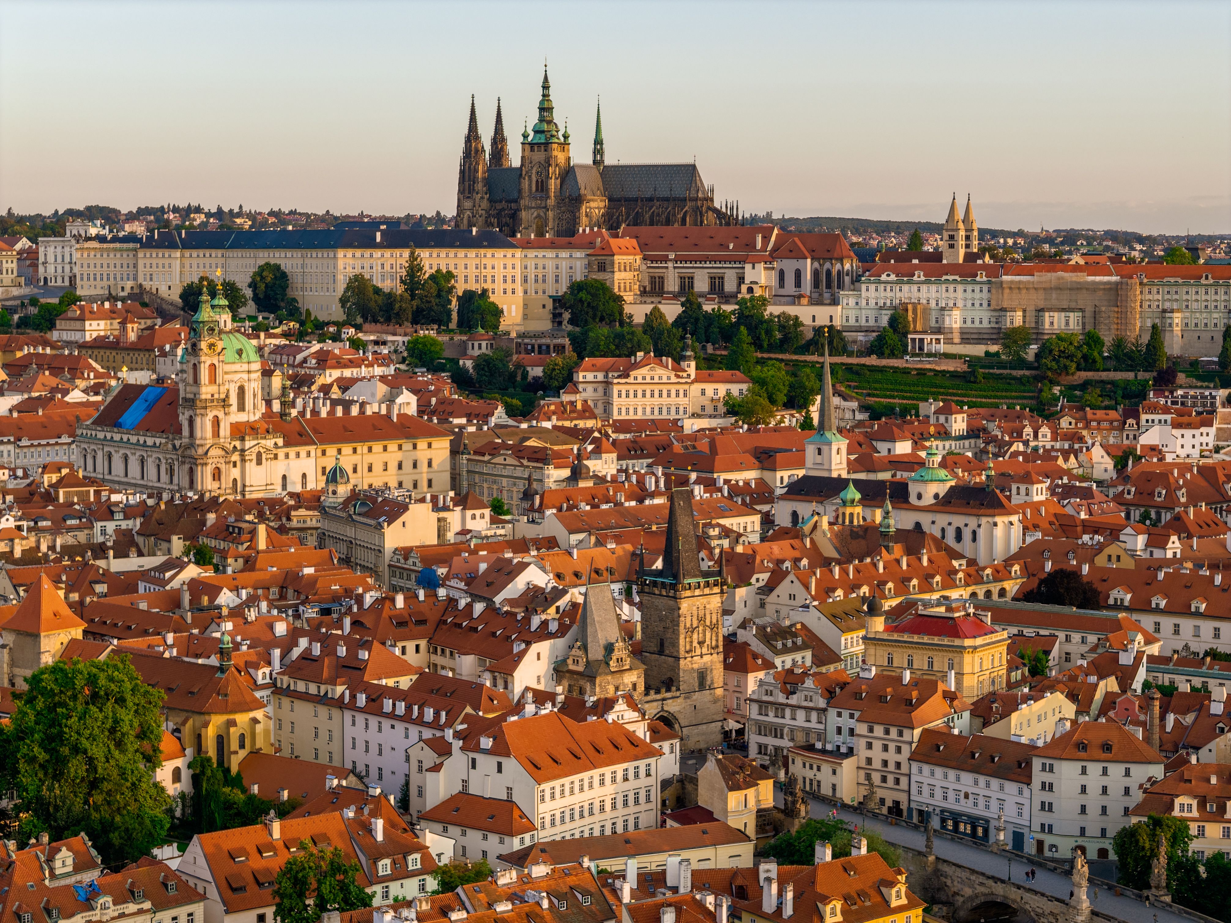 Aerial view of a colorful Eastern European old town at sunset with a river