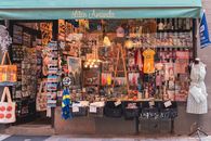 A colorful display of Swedish souvenirs in a quaint shopfront in Stockholm's Gamla Stan district.