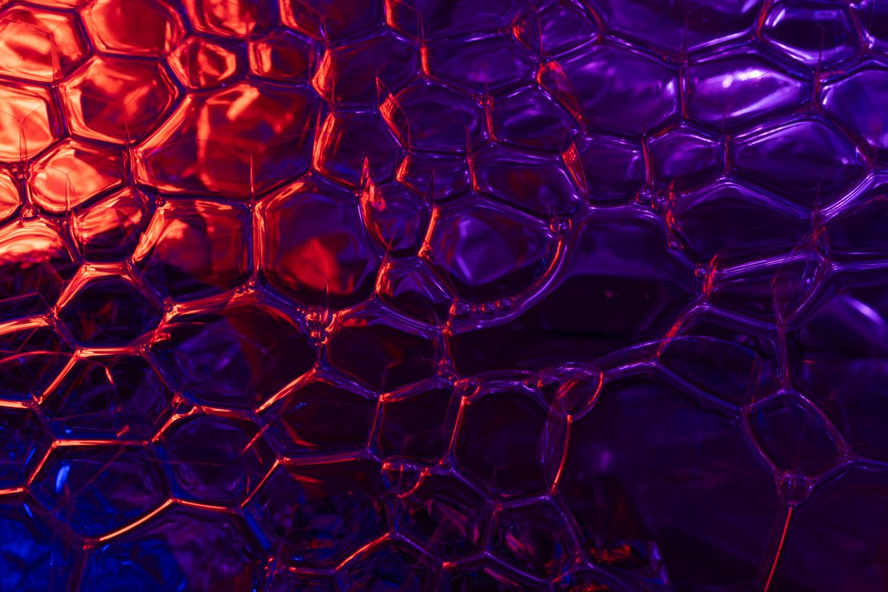 a colorful abstract pattern of bubbles in vibrant neon red and blue hu