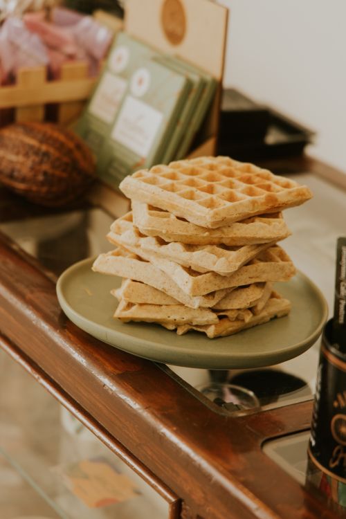 Free Delicious stack of Belgian waffles on a plate in a cozy, rustic setting. Stock Photo