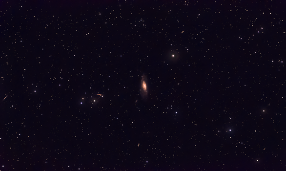 A breathtaking view of deep space featuring a prominent galaxy surrounded by a field of stars.