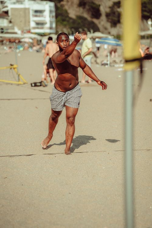 Free A man playing beach volleyball on a sunny day in Lloret de Mar, Spain. Stock Photo