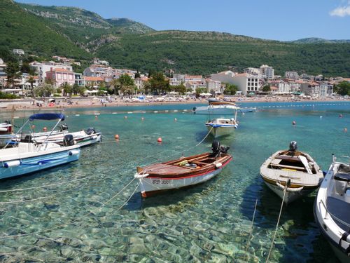 Free Tranquil coastal scene with boats in clear blue waters along Montenegro's beautiful coastline. Stock Photo