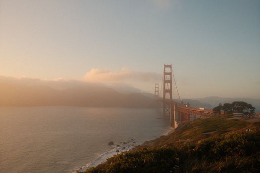 Stunning view of the Golden Gate Bridge during sunset with a misty backdrop in San Francisco.