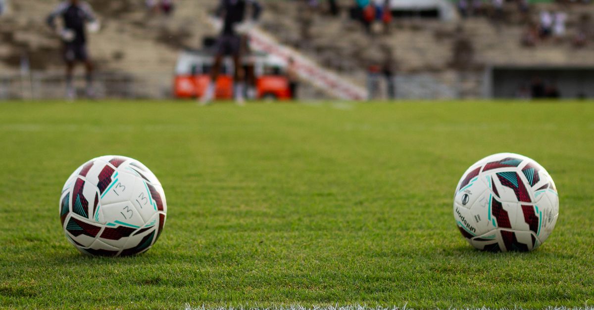 Futuristic football match with holographic offside lines overlaid on the field