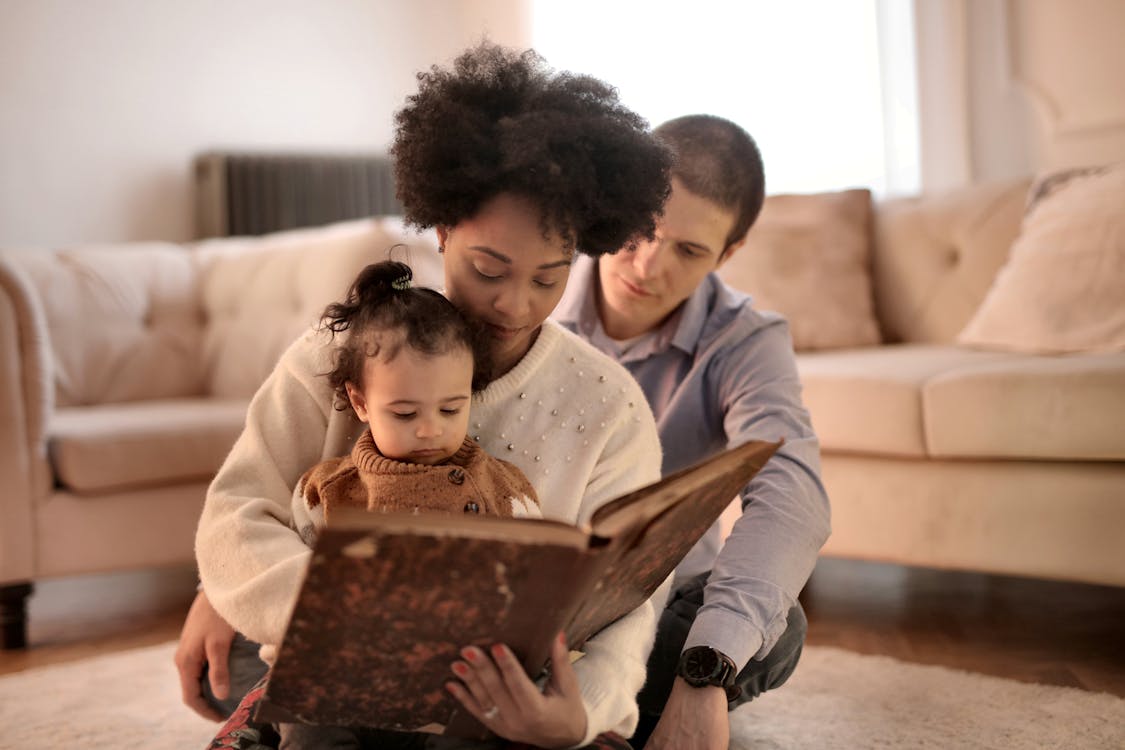 Free Photo of Woman Holding Brown Book With Her Child Stock Photo