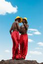 Men Wearing Red Pants and Yellow Hats