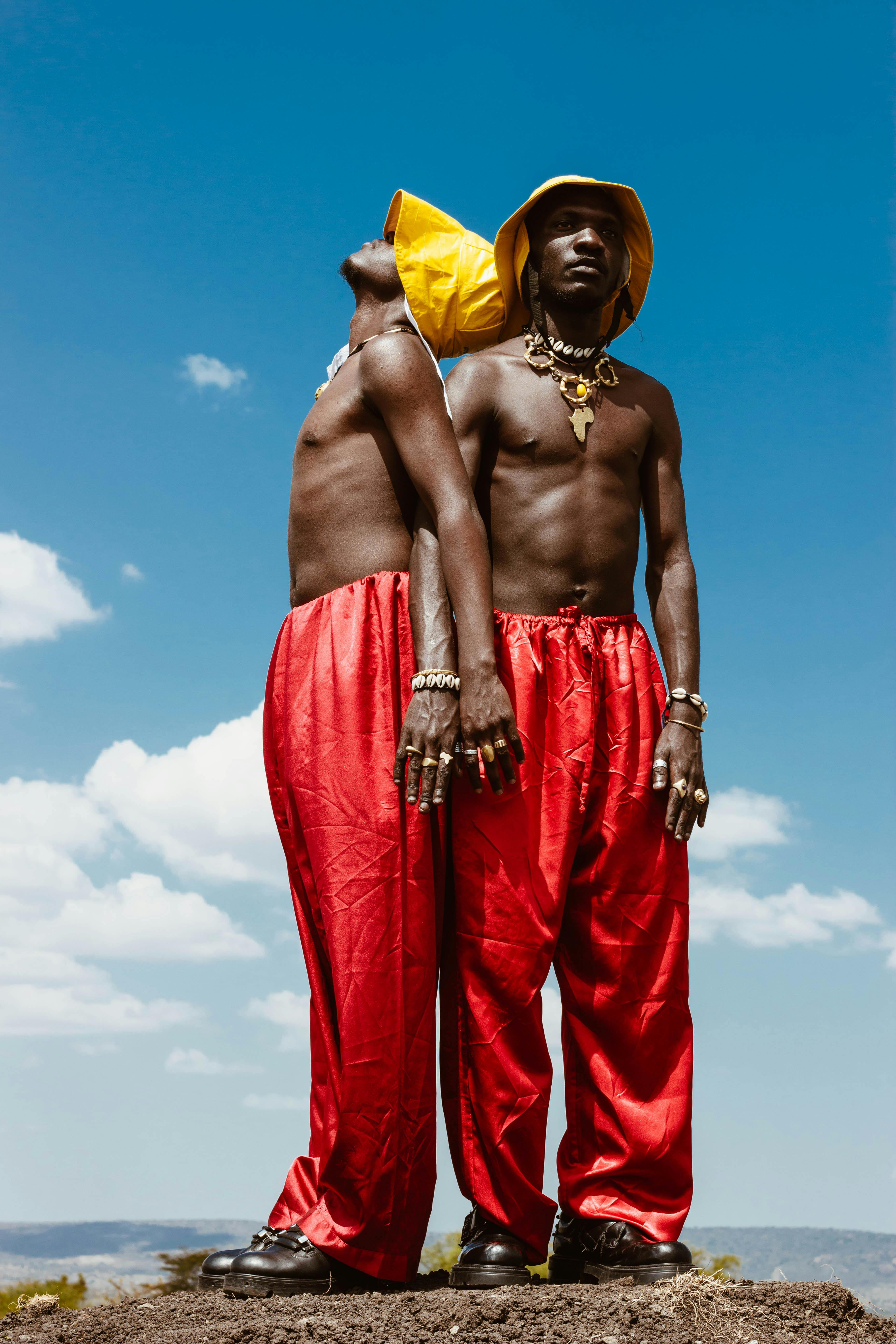 men wearing red pants and yellow hats