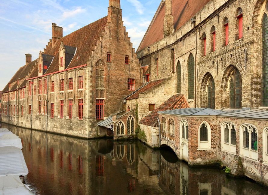 Picturesque canal in Bruges, Belgium, with bicycles parked along the water