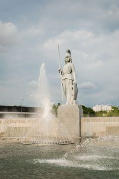 Majestic Minerva statue with fountain in Guadalajara, Mexico. Iconic landmark under cloudy sky.