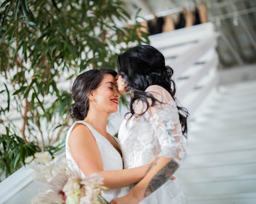 Free Woman in White Floral Dress Kissing Woman in White Dress Stock Photo