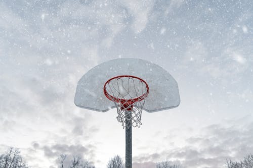 Photo of Basketball Hoop While Snowing