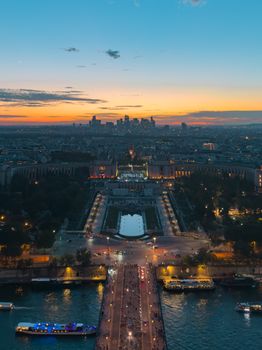 Stunning aerial view of Paris at twilight, capturing the city skyline and Seine River, seen from the Eiffel Tower.