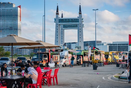 View of lively food truck area near the iconic Terengganu Drawbridge. Perfect for street food enthusiasts.