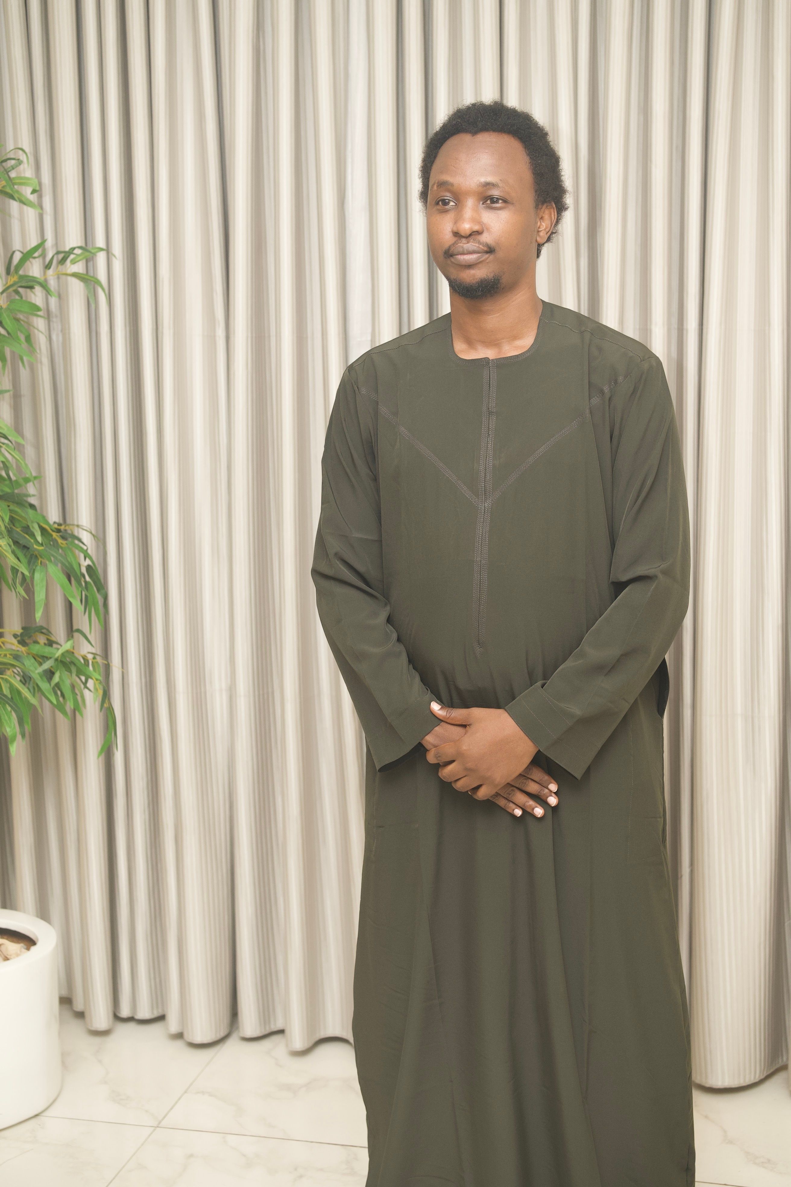 Sophisticated portrait of a man in a traditional kaftan, showcasing modern fashion with cultural roots.