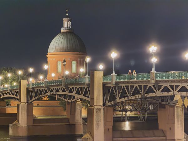 Le dôme de la Grave et le pont Saint-Pierre illuminés la nuit à Toulouse