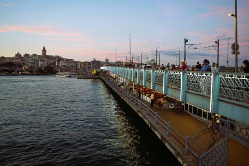 Free A vibrant view of Galata Bridge and Istanbul skyline at sunset, capturing the bustling atmosphere. Stock Photo
