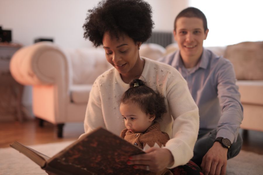 A caregiver reading a storybook with a young child