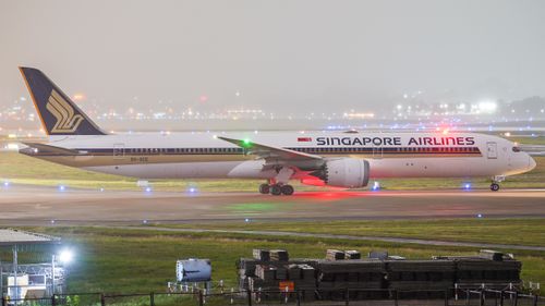 Free Singapore Airlines Boeing 787 Dreamliner taxiing at night on runway. Stock Photo