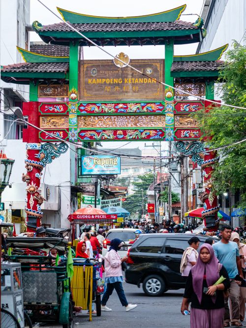 Free Colorful and bustling street scene at Kampoeng Ketandan Gate in Jogja, Indonesia, teeming with people and activity. Stock Photo