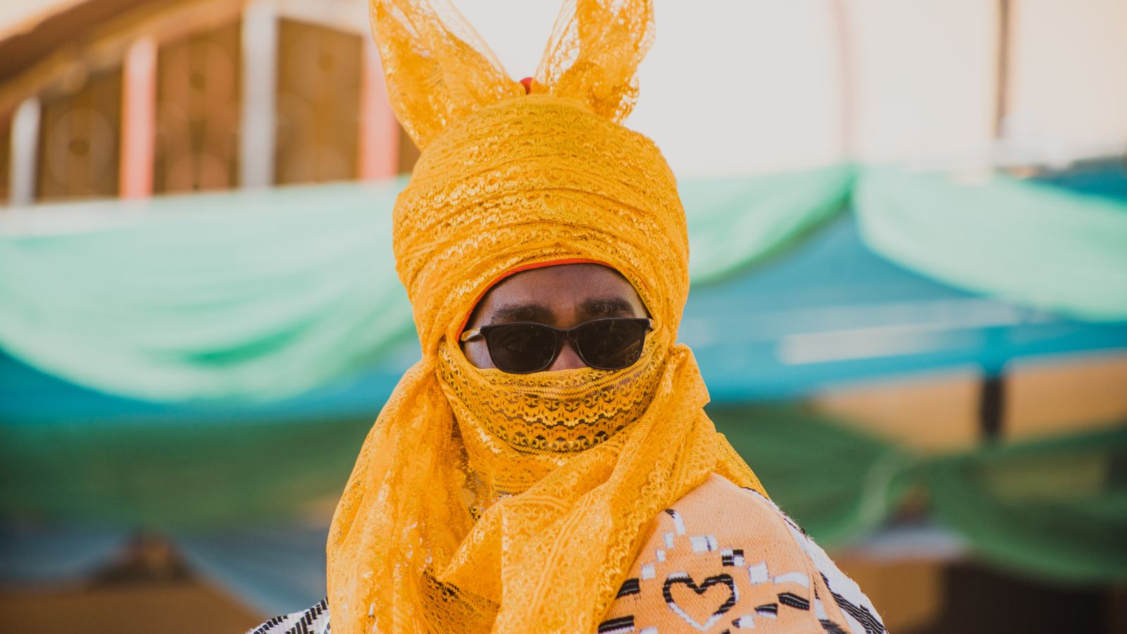 Man in traditional yellow garb and sunglasses, Lesotho