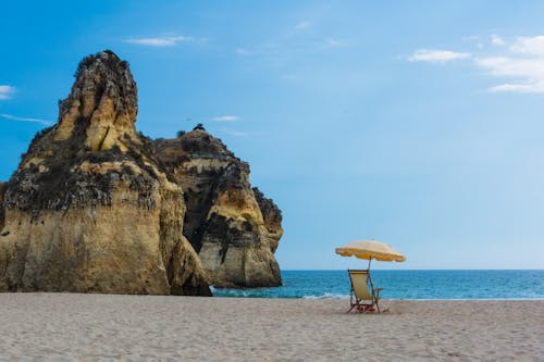 Brown Patio Umbrella Beside Shore Sand