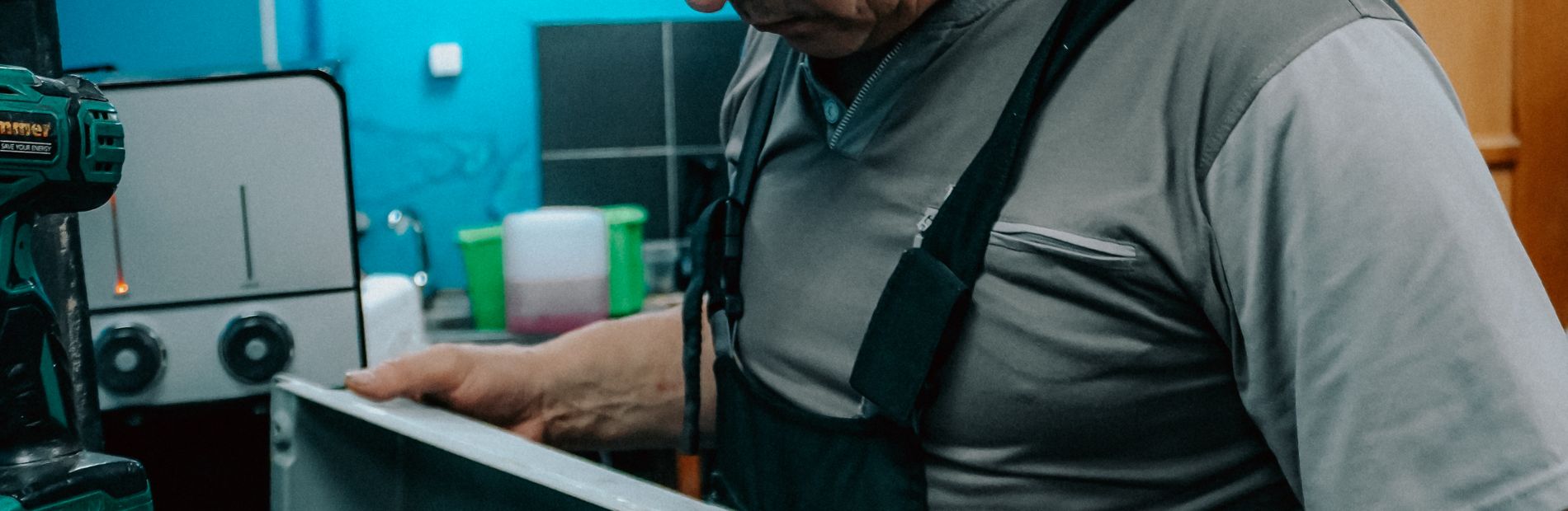 Technicien démontant le capot d'un chauffe-eau