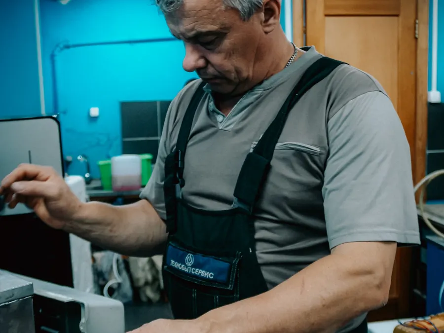 Technician troubleshooting equipment during a maintenance visit