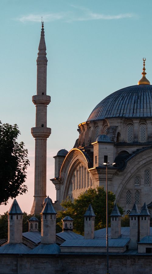 Free Beautiful view of a historic mosque in Istanbul at sunset, featuring a prominent minaret and dome. Stock Photo