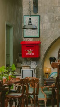 Charming cafe interior in Damascus featuring vintage decor and a bold red letterbox.