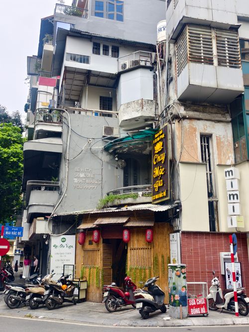 Free Urban street corner in Vietnam with scooters and eclectic architecture. Stock Photo